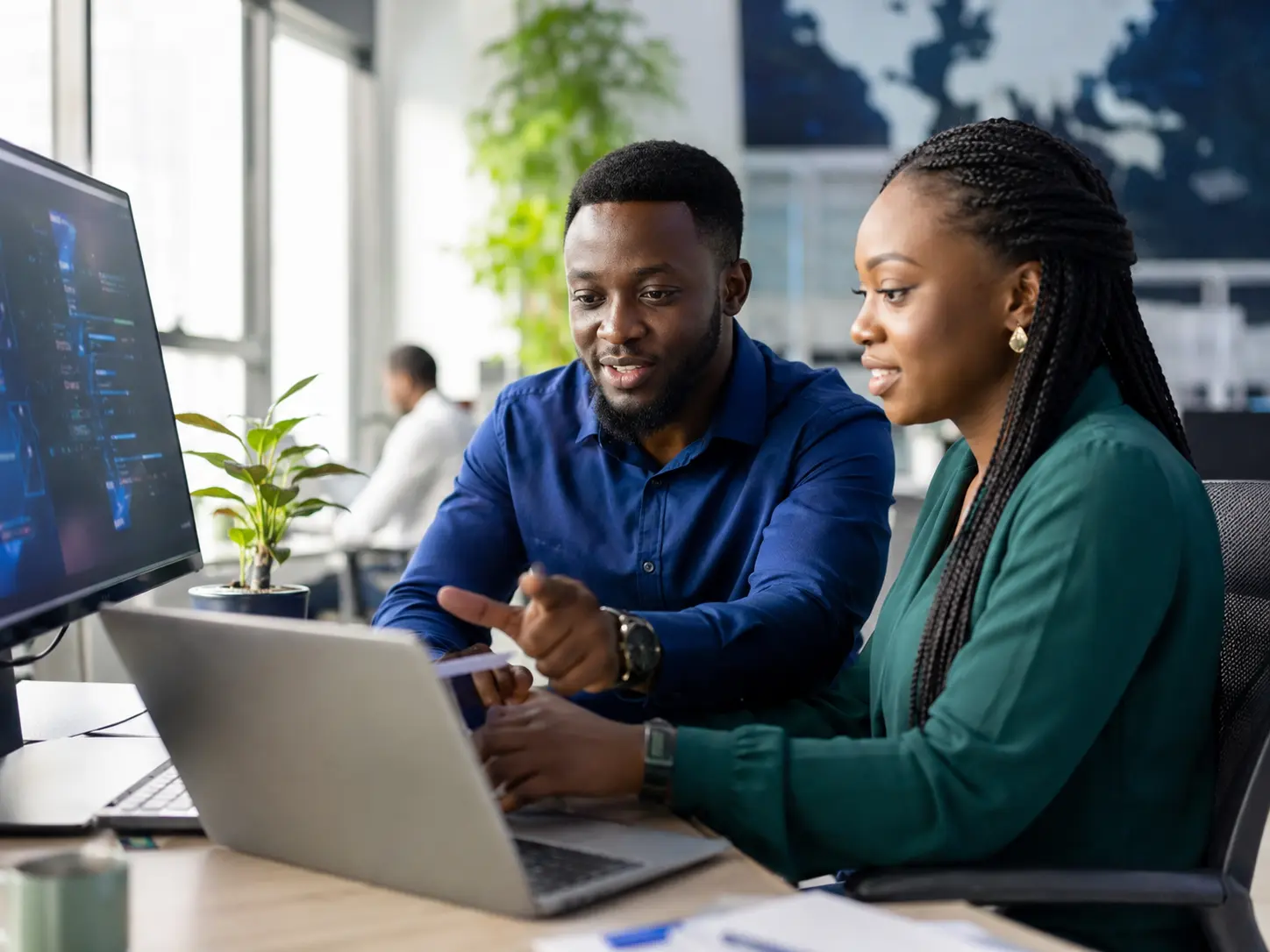African technology consultants collaborating with a business client
