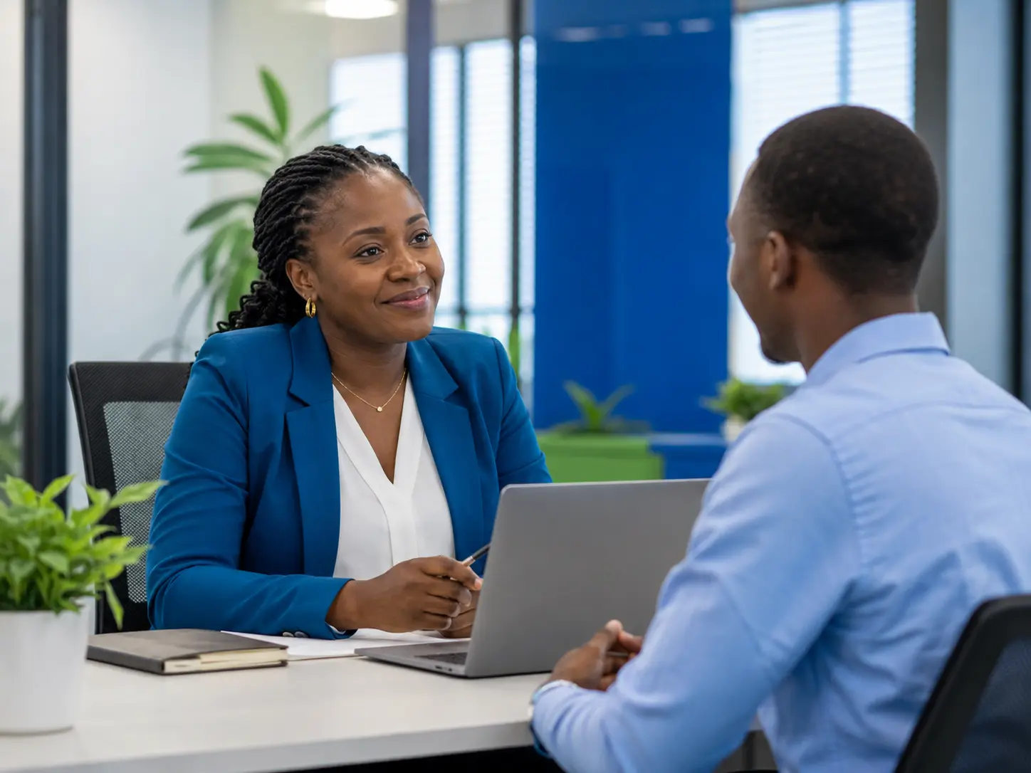 African recruiter interviewing a job candidate in a modern office